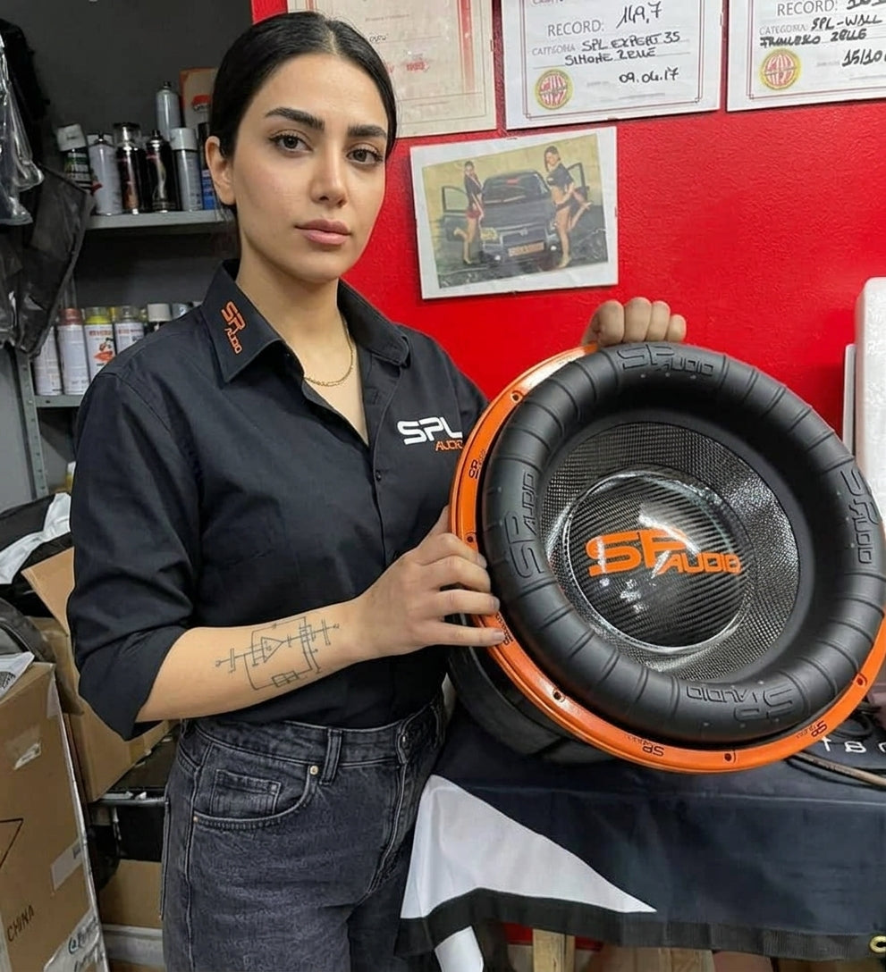 SP Audio technician holding the SP 15XXX 15 inch carbon fibre cone subwoofer in the workshop