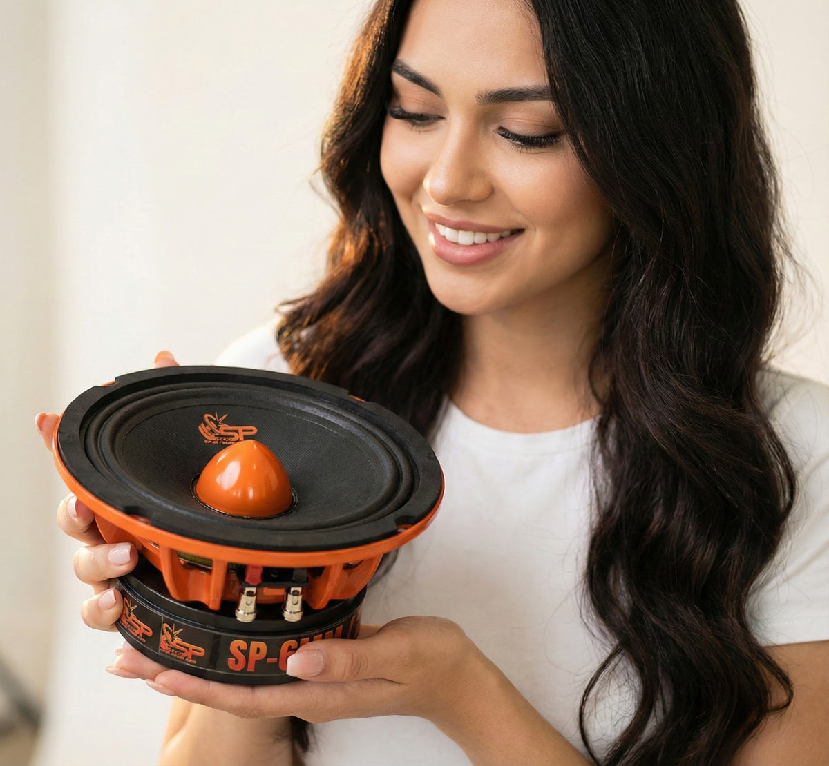 SP 6MM 6.5 inch midrange held in two hands, orange basket and phase plug