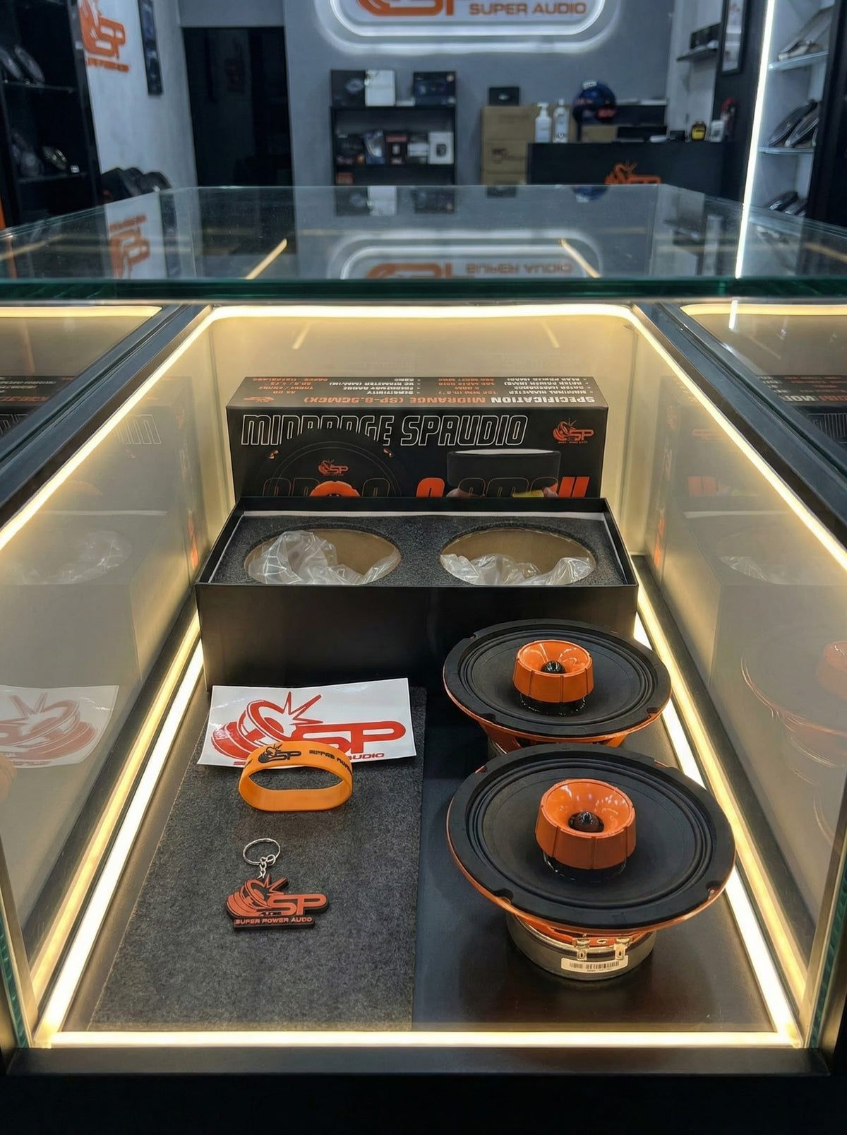SP 6.5CM CX coaxial midrange pair in an illuminated showcase