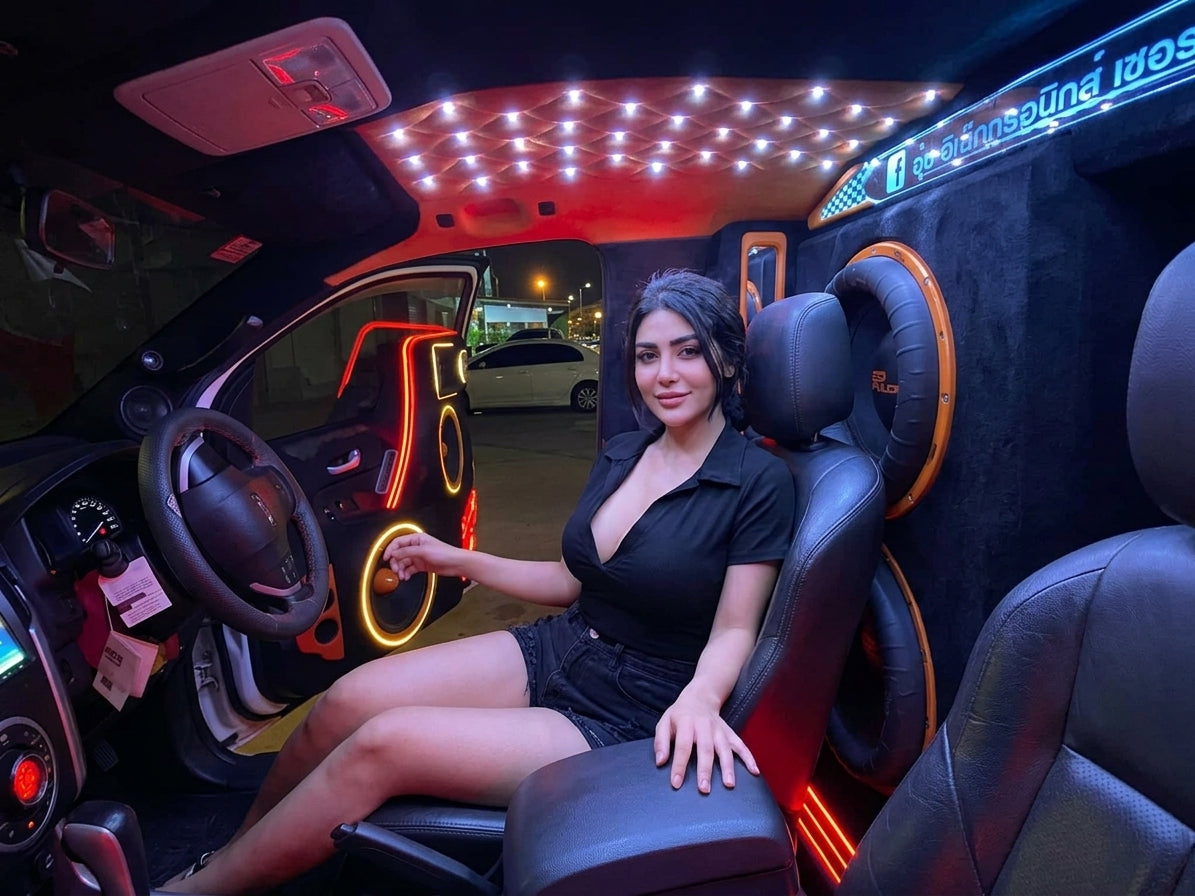 SP Audio 15 inch subwoofers installed behind the seats of a car at night